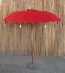 Bali umbrella, chinese red with metal coins and silver hearts hanging around the edge, ø 230 cm and 250cm height 